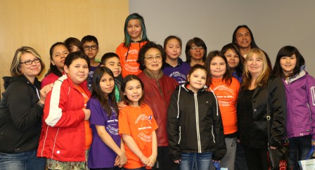 Students pose for a picture with author, Margaret Pokiak-Fenton after listening to her read from her book "Fatty Legs" during Education Day at the TRC event in Edmonton. Photo by Terry Lusty