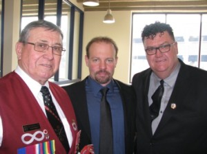 Elder Donald Langford, MC Michael Borowiecki and Principal Fred Hines congratulate the graduating students on a successful year