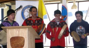 Elder Whiskeyjack participates in school ceremonies with the student drummers 