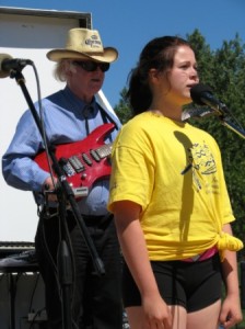 Thirteen year old Ayla Cardinal, accompanied on guitar by musician Don Jenken, sings the National Anthem during the Nationa Aboroginal Day opening ceremonies in St. Albert on June 22