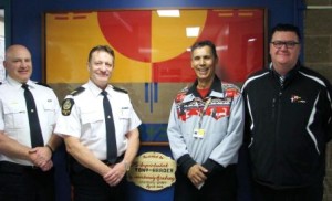 (l-r) Edmonton Police Services Inspector Graham Hogg. EPS Superintendent Tony Harder, Amiskwaciy Elder Francis Whiskeyjack and Principal Fred Hines showcase an honour blanket framed as a symbol of the growing relationship between the Academy and EPS.