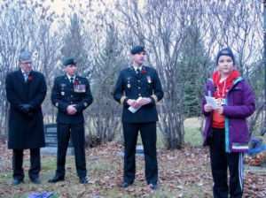 St. Albert Mayor Nolan Crouse is joned by Master Warrant Officer Paul Albertson and Major Phil Joe as Grade 5 student Sarah Gapp addresses the gathering.