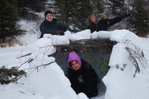 Kayley Van Schaik, Grade 7-12 CTS Teacher (left), Celeste Anderson, Grade 11, Atikameg School (right), Shenatah Cardinal, Grade 11, Cadotte Lake School. This trio learn how to build a quinzhee.