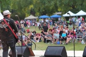 Will Belcourt performing at a summer festival.