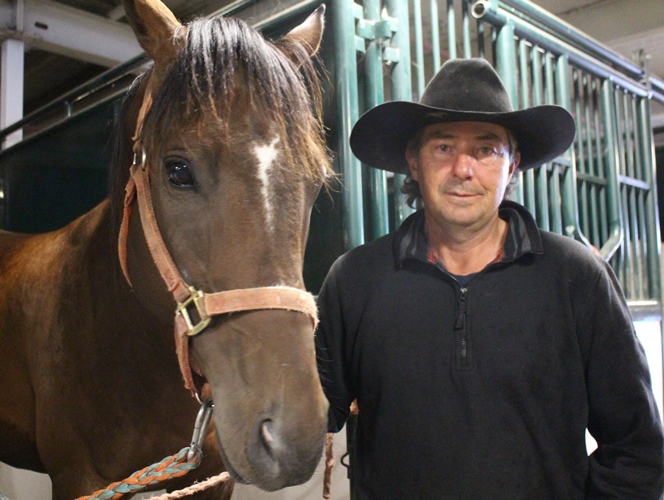 Chuckwagon driver Roger Moore with one of his horses, Blue.  Photo by Terry Lusty