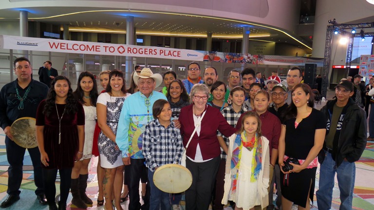Alex and Jacqueline Janvier gather with family following the unveiling of the magnificent floor mural at Rogers Place opening event in Edmonton.