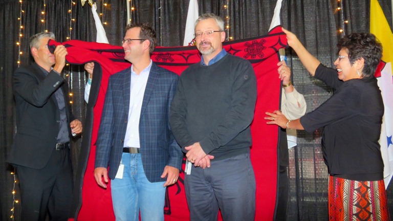 EPSB Superintendent Darrel Robertson and Amiskwaciy Elder Jeanette Lean present Honour Blankets to Chris Wright, Director of Infrastructure (EPSB) and Fraser Methuen, Manager of the EPSB Distribution Centre.