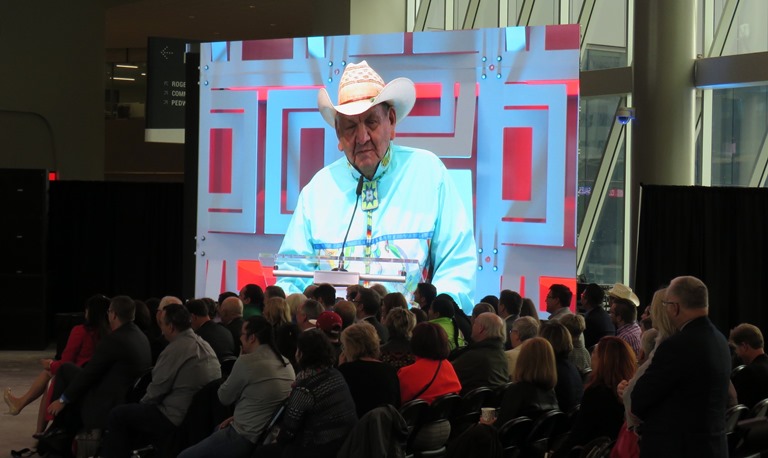 While Alix Jamvier spoke from the podium, his family and close friends looked on.