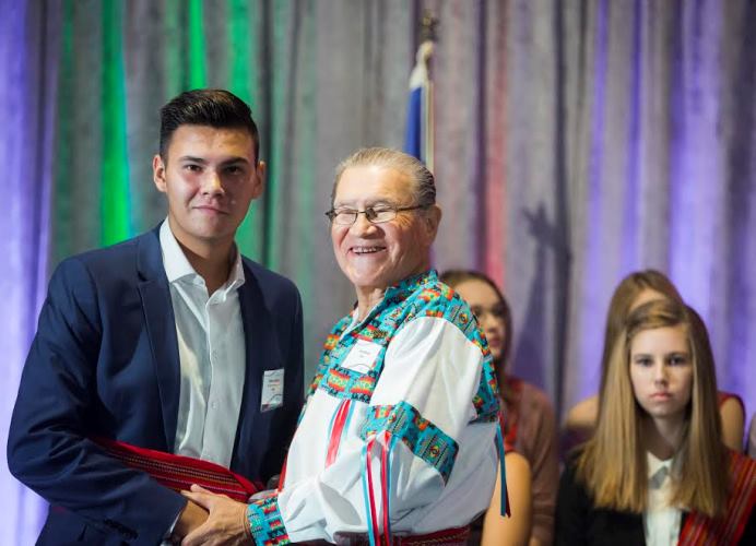 Elder Jerry Wood with an award recipient. 