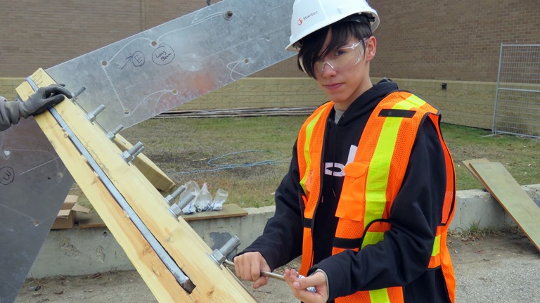 Grade 11 Amiskwaciy Construction Class student Dustin Byer tightens bolts as he participates in building the school's new traditional sweat lodge.