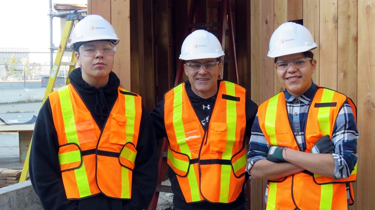 Amiskwaciy shop instructor Larry Moro is flanked by students Keeston Young and Brylee Gladue, two of about 15 students who helped work on the construction project