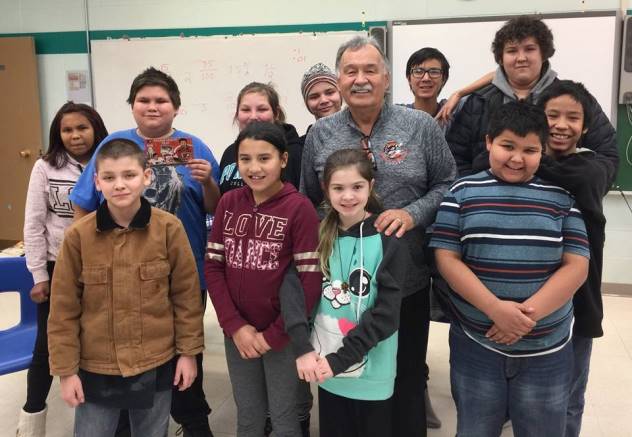 Hockey legend Reggie Leach poses with students from Conklin Alberta. 